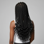 Back view of a woman with Royal Boho Knotless Braids in a solid jet black color, showcasing long, wavy black ends, on a plain background.